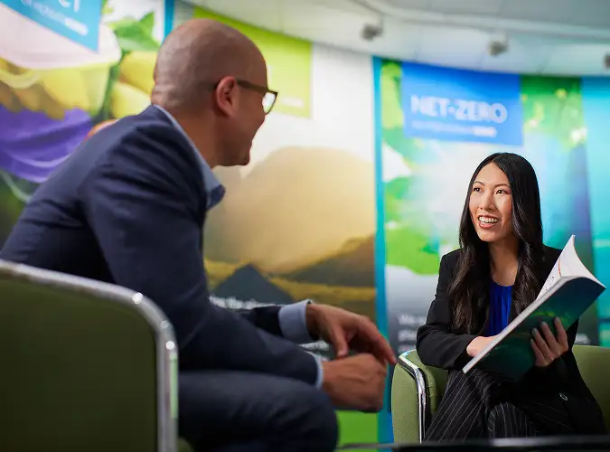 Two professionals reviewing a change management strategy diagram