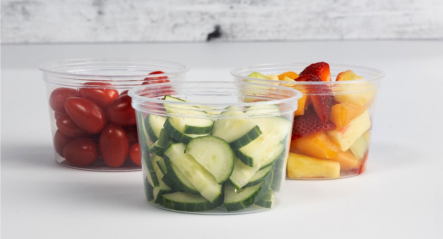 Sliced vegetables and fruit in clear plastic containers