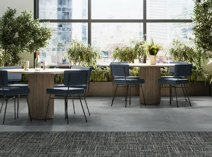 Public dining area with lots of plants on LVT and carpet flooring