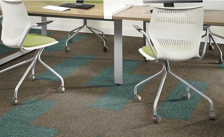 close up of office desk area with gray field carpet and teal insets