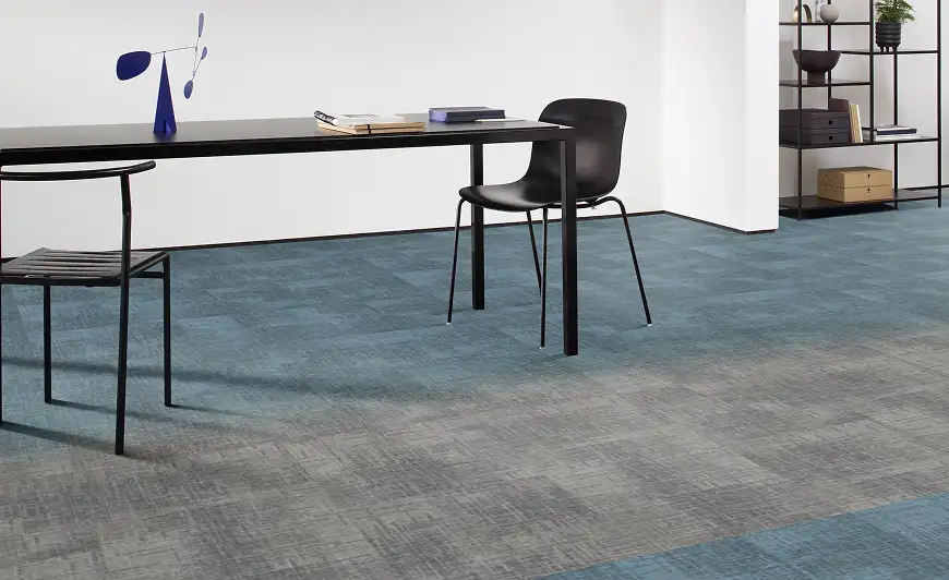 desk and chair on teal and grey hobre carpet tiles