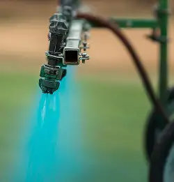 close up of Blazon spray indicator being sprayed on turf