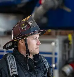 Fire fighter in station looking off into the distance