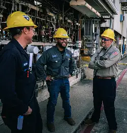 workers wearing hard hats wearing clothing made with Milliken textiles