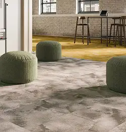 3 soft green stools on a tan carpet tile installation transitioning to the yellow carpet tile installation