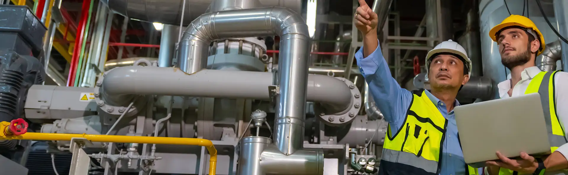 Manufacturing leaders collaborating on a change management strategy session on a plant floor