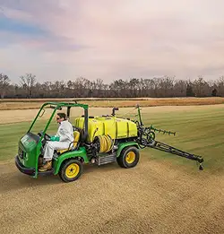 farm sprayer with person driving in field