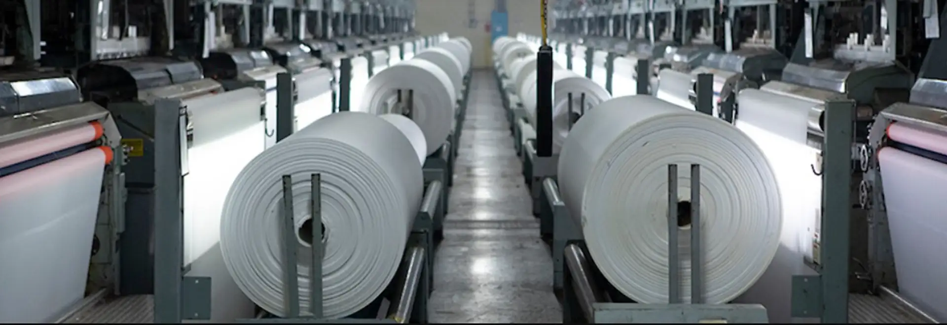 Textile manufacturing plant floor with rolls of fabric 