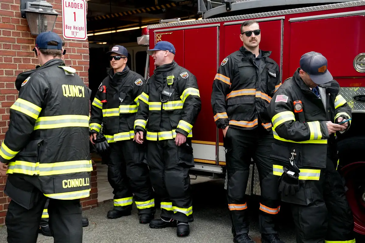 quincy firefighters in front of truck wearing gear