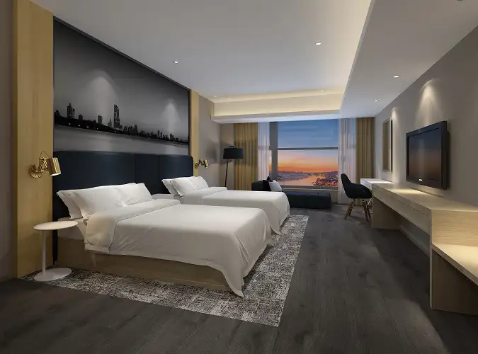 Hotel guestroom with LVT and a carpeted inset around the beds