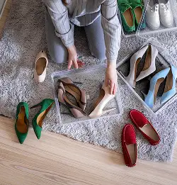 person putting shoes in clear containers