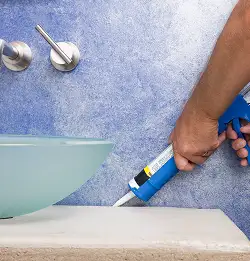 close shot of person chalking around a sink area