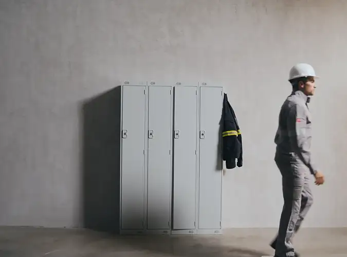 person in workwear walking past locker