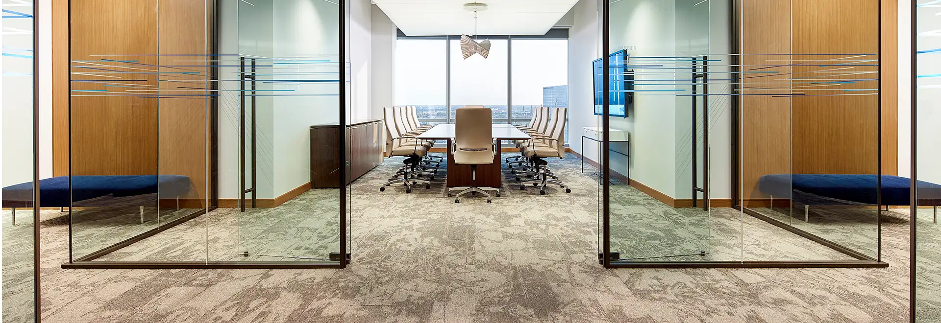 High end meeting space with glass walls lether chairs and SDN carpet tile 