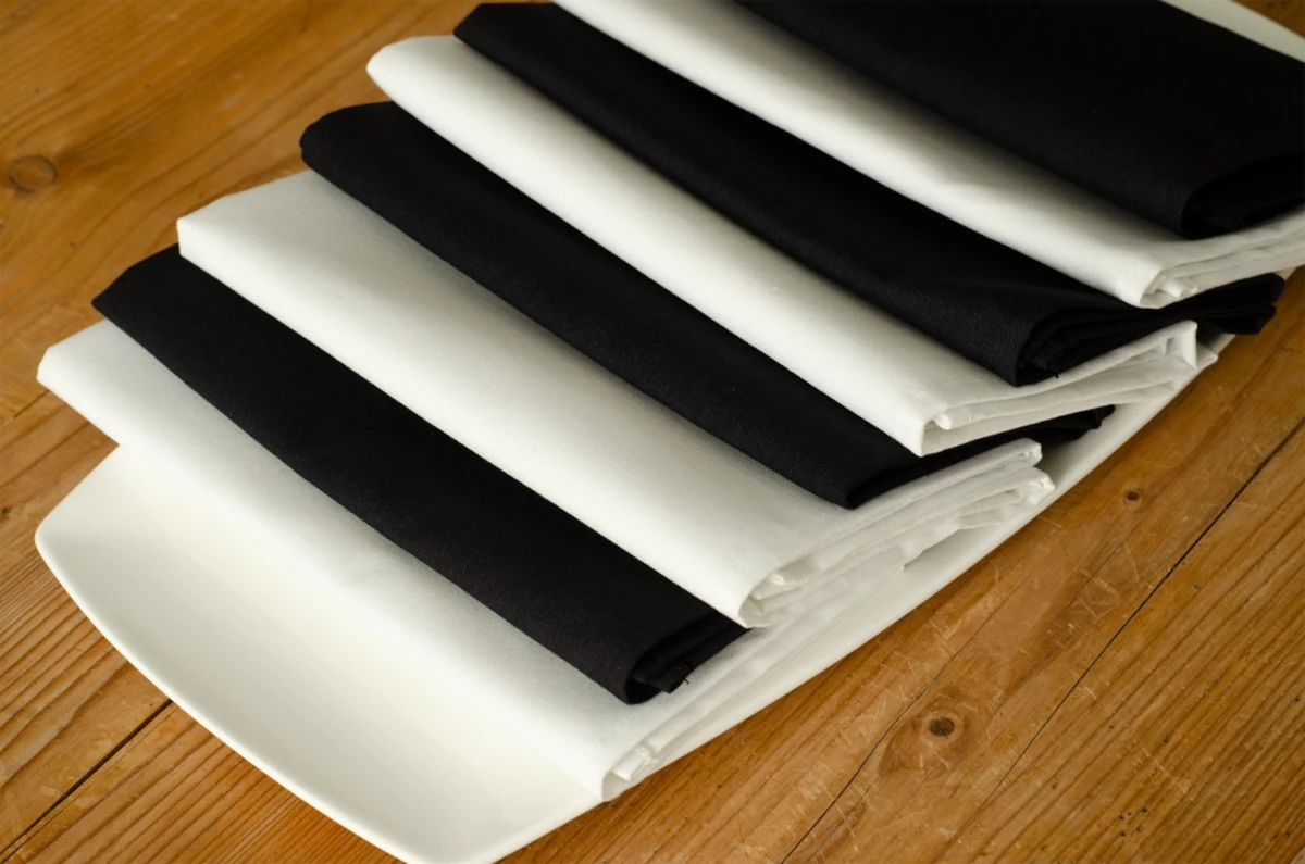 White and black folded linens stacked on one another