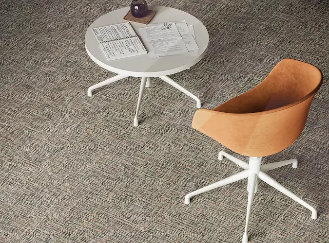 chair and table seen from above on carpet tile flooring