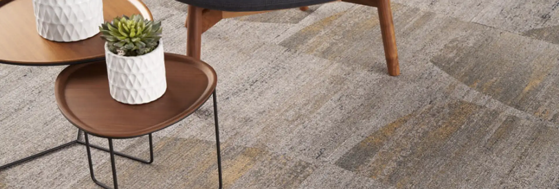close up of chair on textural carpet tile flooring