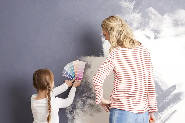 woman an child painting a wall