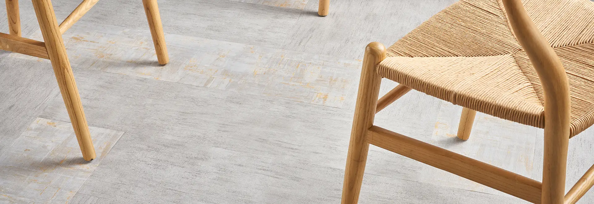close up of blonde wood chairs on LVT flooring
